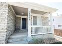 Inviting front porch with stone accents, creating a welcoming entrance to the home at 18656 E Harvard Dr, Aurora, CO 80013