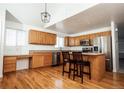 Bright kitchen featuring stainless steel appliances and a functional center island with bar stool seating at 18656 E Harvard Dr, Aurora, CO 80013