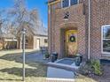 Inviting front entrance with a decorative wreath on the wooden door and potted plants adding to the curb appeal at 2540 Forest St, Denver, CO 80207