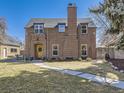 Charming brick two-story home with manicured lawn, welcoming front door, and a classic architectural design at 2540 Forest St, Denver, CO 80207