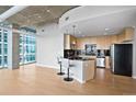 Modern kitchen with breakfast bar and stainless steel appliances at 1700 Bassett St # 1105, Denver, CO 80202