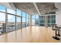 Light and airy living room with hardwood floors and floor to ceiling windows at 1700 Bassett St # 1105, Denver, CO 80202