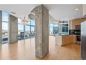 Open concept living area with hardwood floors and city views at 1700 Bassett St # 1105, Denver, CO 80202