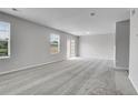 Bright living room featuring large windows with blinds, plush carpeting and neutral paint at 7977 S Kittredge St, Englewood, CO 80112
