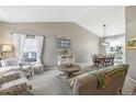 Bright living room with vaulted ceiling, neutral paint, and comfortable seating arrangement at 4644 W 112Th Ct, Westminster, CO 80031