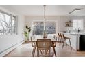 Sunlit dining room featuring a stylish table, chairs, and a view of the outdoor space at 3400 Moore St, Wheat Ridge, CO 80033