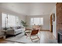 Bright and airy living room with large windows, modern furniture, and hardwood floors at 3400 Moore St, Wheat Ridge, CO 80033