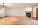 Spacious living room features hardwood floors, fireplace, and modern lighting at 23678 Pondview Pl # D, Golden, CO 80401