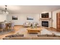 Staged living room boasts a stone fireplace, stylish decor, and comfortable seating arrangement at 23678 Pondview Pl # D, Golden, CO 80401