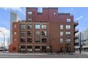 Multi-story brick building, multiple windows and balconies at 1800 Lawrence St # 408, Denver, CO 80202