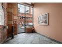 Building lobby with brick walls, tile floor, and city view at 1800 Lawrence St # 408, Denver, CO 80202