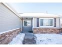 Gray exterior with brick base and snowy front yard at 2030 Santana Dr, Castle Rock, CO 80104