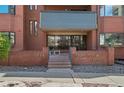 Governor's Abbey brick entrance features a small seating area and glass front doors at 534 E 7Th Ave # 206, Denver, CO 80203