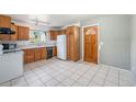 Bright kitchen with ample cabinet space, white appliances, and tile flooring at 2109 Jackson St, Golden, CO 80401
