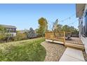 Backyard featuring a wooden deck that leads to a lush lawn, perfect for relaxation and play at 9544 Longford Way, Parker, CO 80134