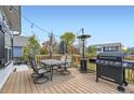 Spacious wooden deck with dining set and grill, perfect for outdoor entertaining at 9544 Longford Way, Parker, CO 80134