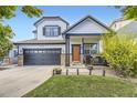 Inviting two-story home boasts a two-car garage, stone detailing, and a manicured lawn at 9544 Longford Way, Parker, CO 80134