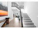 Modern staircase with metal railing and light-colored carpet at 6307 E 141St Ln, Thornton, CO 80602