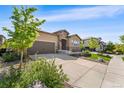 Beautifully landscaped home exterior with a spacious driveway and modern architectural design at 2134 S Poppy St, Lakewood, CO 80228