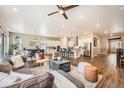 Open-concept living area with hardwood floors, modern decor, and seamless flow to the kitchen at 2134 S Poppy St, Lakewood, CO 80228
