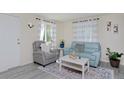 Cozy living room featuring a comfortable recliner and stylish blue sofa at 5525 Pierce Ct, Arvada, CO 80002