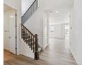 Bright entryway with hardwood floors, staircase, and open access to the living area at 24778 E 40Th Ave, Aurora, CO 80019