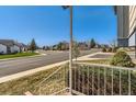 Neighborhood view from the porch showing a quiet street with well-maintained homes and lawns at 11437 W 103Rd Ave, Broomfield, CO 80021