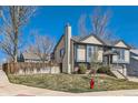 Suburban two story home featuring neutral siding, landscaped yard, brick accents, and a side access garage at 11437 W 103Rd Ave, Broomfield, CO 80021
