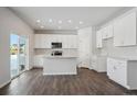 Well lit kitchen featuring white cabinets, stainless steel appliances and island at 1432 Orchard St, Brighton, CO 80601