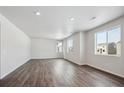 Spacious living room featuring hardwood floors, ample lighting, and many windows offering great views at 1432 Orchard St, Brighton, CO 80601
