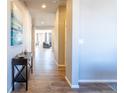 Inviting foyer with hardwood floors that transition into a living area with stylish furnishings at 26960 E Costilla Dr, Aurora, CO 80016