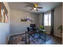 Bright home office with large window, hardwood floors, and modern decor at 26960 E Costilla Dr, Aurora, CO 80016