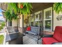 Relaxing front porch with comfortable seating, hanging ferns and mountain views at 19780 W 57Th Ln, Golden, CO 80403