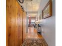 Bright entryway with wood floors and barn door leading to living area at 1801 Wynkoop St # 205, Denver, CO 80202