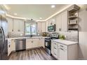 Contemporary kitchen boasts stainless steel appliances and gray subway tile backsplash at 21 Douglas N Dr, Broomfield, CO 80020