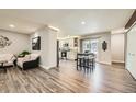 Open-concept layout showcases living room, kitchen with stainless steel appliances, and breakfast nook at 21 Douglas N Dr, Broomfield, CO 80020