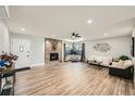 Cozy living room features a stone fireplace, light wood floors, and a window seat at 21 Douglas N Dr, Broomfield, CO 80020