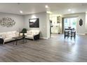 Open-concept floor plan featuring the living room, kitchen, and bar seating on gray floors at 21 Douglas N Dr, Broomfield, CO 80020