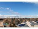 Scenic aerial view of neighborhood with trees and mountain range in the distance at 155 S Monaco Street Pkwy # 311, Denver, CO 80224