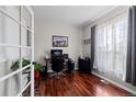Bright and airy office space with French doors, hardwood floors, and a large window with natural light at 5611 S Sicily Cir, Aurora, CO 80015