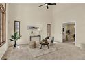 Bright living room with high ceilings, a ceiling fan, and abundant natural light from multiple windows at 70 Long Bow Cir, Monument, CO 80132