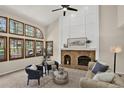 Cozy living room with a brick fireplace, large windows, and comfortable seating at 70 Long Bow Cir, Monument, CO 80132