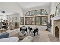 Spacious living room featuring a wall of windows, fireplace and comfortable seating at 70 Long Bow Cir, Monument, CO 80132