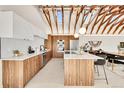 Spacious modern kitchen with wood grain and white cabinets, stainless appliances, and an island with counter seating at 2244 S Franklin St, Denver, CO 80210