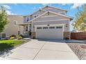 Charming two-story home featuring a covered porch, manicured lawn, and a two-car garage at 15131 Munich Ave, Parker, CO 80134