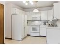 Bright kitchen featuring white appliances and plenty of cabinet space at 665 S Alton Way # 4B, Denver, CO 80247