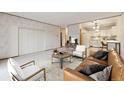 Comfortable living room featuring a soft couch and an open kitchen view at 665 S Alton Way # 4B, Denver, CO 80247