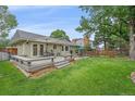 Expansive backyard with a spacious deck, perfect for outdoor entertaining and relaxation at 8116 W Fremont Dr, Littleton, CO 80128