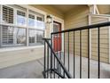 Front door features 908 address number and a black metal railing to the door's entrance at 5800 Tower Rd # 908, Denver, CO 80249