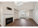 Open-concept living room features a fireplace, vaulted ceilings, and light-filled windows at 5800 Tower Rd # 908, Denver, CO 80249